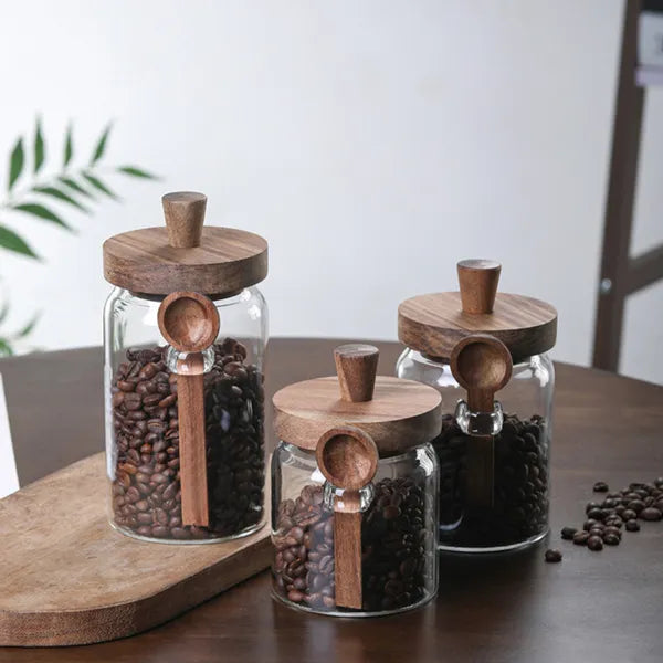 Three glass storage jars filled with pantry staples