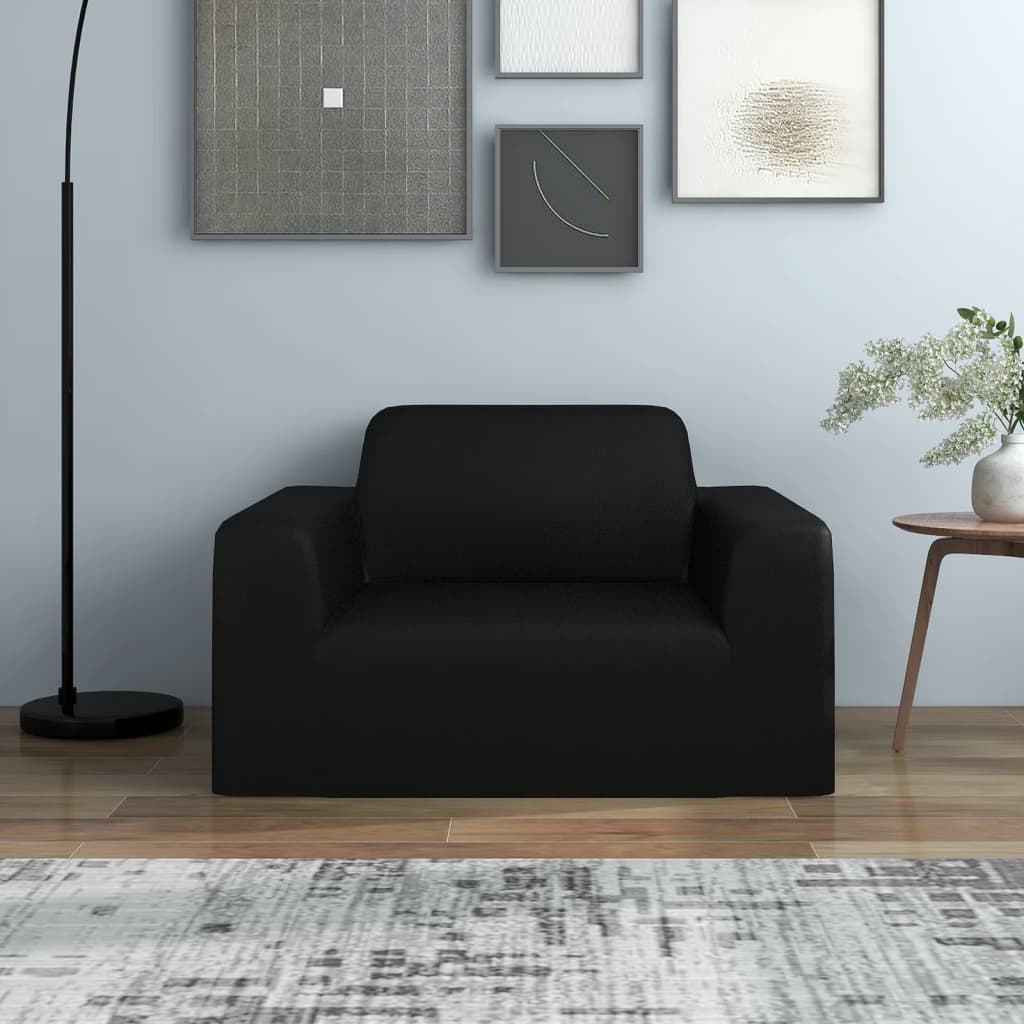 Casora black stretch cover fitted on a 1-seater armchair